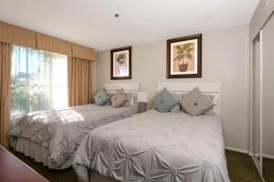 a hotel room with two beds and a window at Parc Corniche Condominium Suites in Orlando