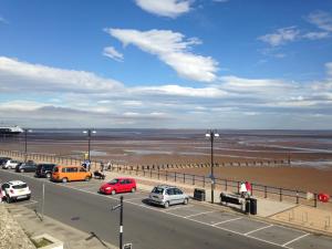 a highway with cars parked on it next to the beach at Lovely little flat by the sea in Cleethorpes in Cleethorpes