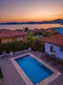 a swimming pool in front of a house at Villa Cavit Bey in Marmaris