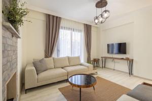 a living room with a couch and a table at Villa Cavit Bey in Marmaris
