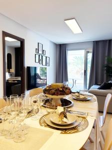 a dining room table with glasses and food on it at Maribel Apartamento Moderno in Marbella
