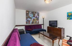 a living room with a couch and a tv at Beautiful Apartment In Ika With Wifi in Ika