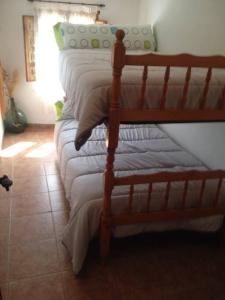 two bunk beds in a room with a floor at Casa Rural El Abejorro in La Gila