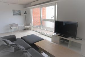 a living room with a couch and a flat screen tv at Vesterhavsgade 47. door 25 (id. 076) in Esbjerg