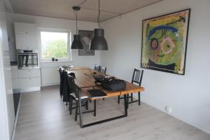 a dining room table with chairs and a painting on the wall at Vesterhavsgade 47. door 25 (id. 076) in Esbjerg
