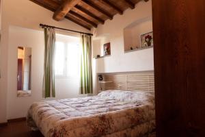 Schlafzimmer mit einem großen Bett und einem Fenster in der Unterkunft Case vacanze Santamargherita in Castiglione della Pescaia