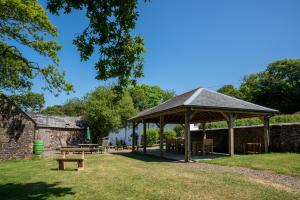 a pavilion with tables and benches in a park at Foxglove in Week Saint Mary