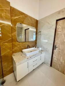 a bathroom with a sink and a mirror at Villa MYSA in Rāmgarh