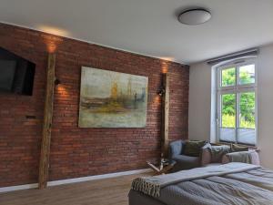 a bedroom with a brick wall and a bed at Haus Gezeiten in Meldorf