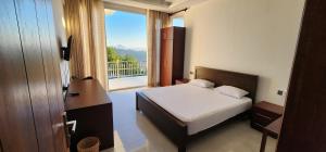 a bedroom with a bed and a large window at The Cloud Hanthana, Kandy in Kandy