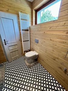 a bathroom with a toilet and a window at Ski eden in Mýto pod Ďumbierom