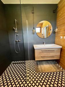 a bathroom with a sink and a mirror at Ski eden in Mýto pod Ďumbierom