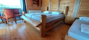 a bedroom with two beds and a table and chairs at House Jaro in Velenje