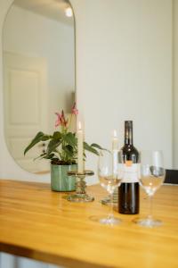 a table with two bottles of wine and glasses at Luxury apartment close to the sea in Kuressaare