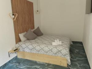 a bed with two white shoes sitting on top of it at Diamond Rezidente III in Timişoara
