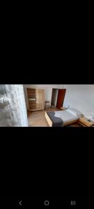 two pictures of a bedroom with a bed and a couch at Jasna 2 in Stari Grad