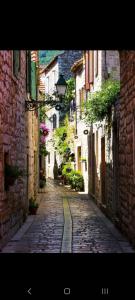an alley with a cobblestone street in a city at Jasna 2 in Stari Grad
