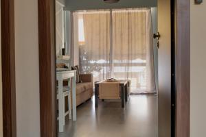 a living room with a couch and a window at Modern Cozy Apartment in Downtown Athens in Athens