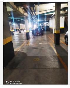 a parking garage with a motorcycle parked in it at Apartamento moderno com 03 quartos e 02 garagens in Campinas