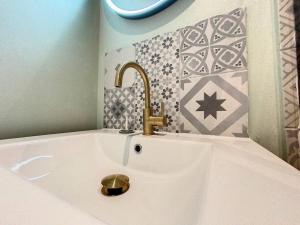 a white sink with a gold faucet in a bathroom at Le Libé 206 - Quartier libération - Centre Ville in Nice