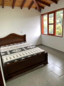 a bed sitting in a room with a window at Hermosa vista GH #4 in Guarne