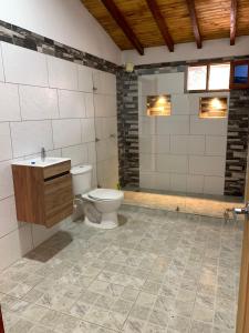 a bathroom with a toilet and a sink at Hermosa vista GH #4 in Guarne