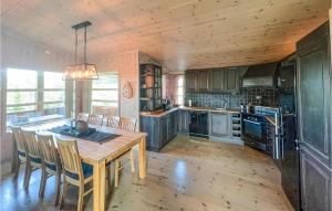 a large kitchen with a wooden table and chairs at 4 Bedroom Gorgeous Home In Nord-Torpa in Nord Torpa