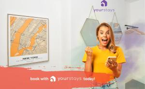 a woman holding a cell phone in front of a map at Keary House by YourStays, Stoke, with a touch of Scandinavia, 3 bedrooms, BOOK NOW! in Stoke on Trent