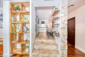 a staircase in a home with wooden shelves at Peaceful Haven, Terrace in Nice in Nice