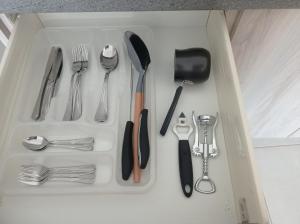 a tray filled with utensils in a drawer at Pireas view in Piraeus