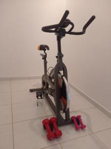 a exercise bike with red wheels on a tile floor at Pireas view in Piraeus