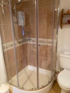 a shower stall in a bathroom with a toilet at The Manger at Bethersden, nr Tenterden and Ashford in Bethersden
