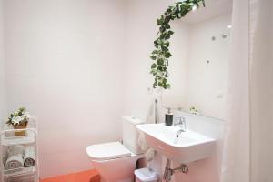 a bathroom with a white toilet and a sink at Ibanova Homes Casco Antiguo 1 in Valencia