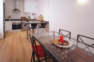 a kitchen with a glass table with a plate of food on it at Hogar moderno cerca de Casco Antiguo de Valencia in Valencia +11 photos