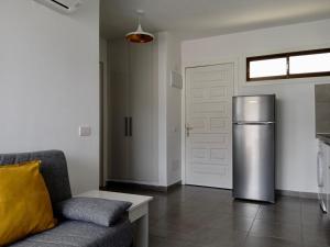 a living room with a refrigerator and a couch at Apartamento Robi en Cumana II - Puerto Rico - Ap 508 in Puerto Rico de Gran Canaria