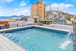 a swimming pool on the roof of a building at Casa Barros Vacation Condos in Mazatlán