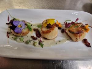 a white plate with food on a table at Portsonachan Hotel & Lodges in Dalmally