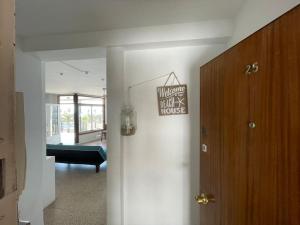 a hallway with a house sign on a door at Apartamento en primera línea de mar de Salou in Salou