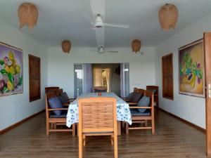 a dining room with a table and chairs at La Résidence Tiako in Ambondrona