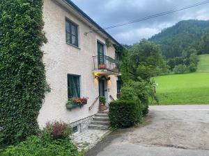 a building with a balcony and stairs in front of it at Apartment Thomabauerhof in Oberzeiring