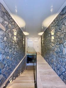 un mur en pierre dans un couloir avec un escalier dans l'établissement TEA Luxury - Praia a Mare, à Praia a Mare