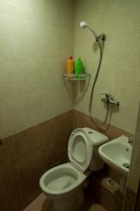 a bathroom with a shower and a toilet and a sink at Blue Sky Hotel in Hong Kong