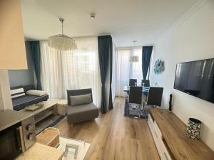 a living room with a couch and a dining room at GH Apartment Admiral Sveti Vlas in Sveti Vlas