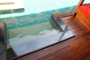 a glass door on a wooden deck with a pool at Avatar Railay in Railay Beach