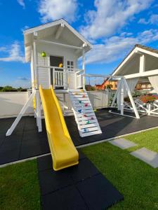 a playground with a slide and a house at Krystal Boutique Mansion in Hunedoara