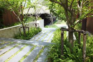 a walkway in a garden with a tree at Avatar Railay in Railay Beach
