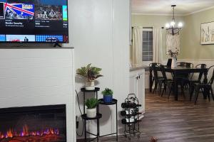 a living room and a dining room with a fireplace at Cozy Cottage with Full View of the Mountains! in Blue Ridge
