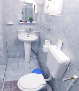 a white bathroom with a sink and a toilet at Casa Ysa in Vama Veche
