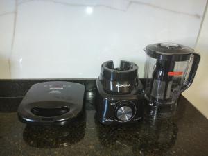 a blender and a coffee maker on a counter at 101 Apartamento em Aracruz ES in Aracruz