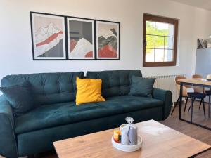 a green couch in a living room with a table at Villa Luce in Kolašin +36 photos